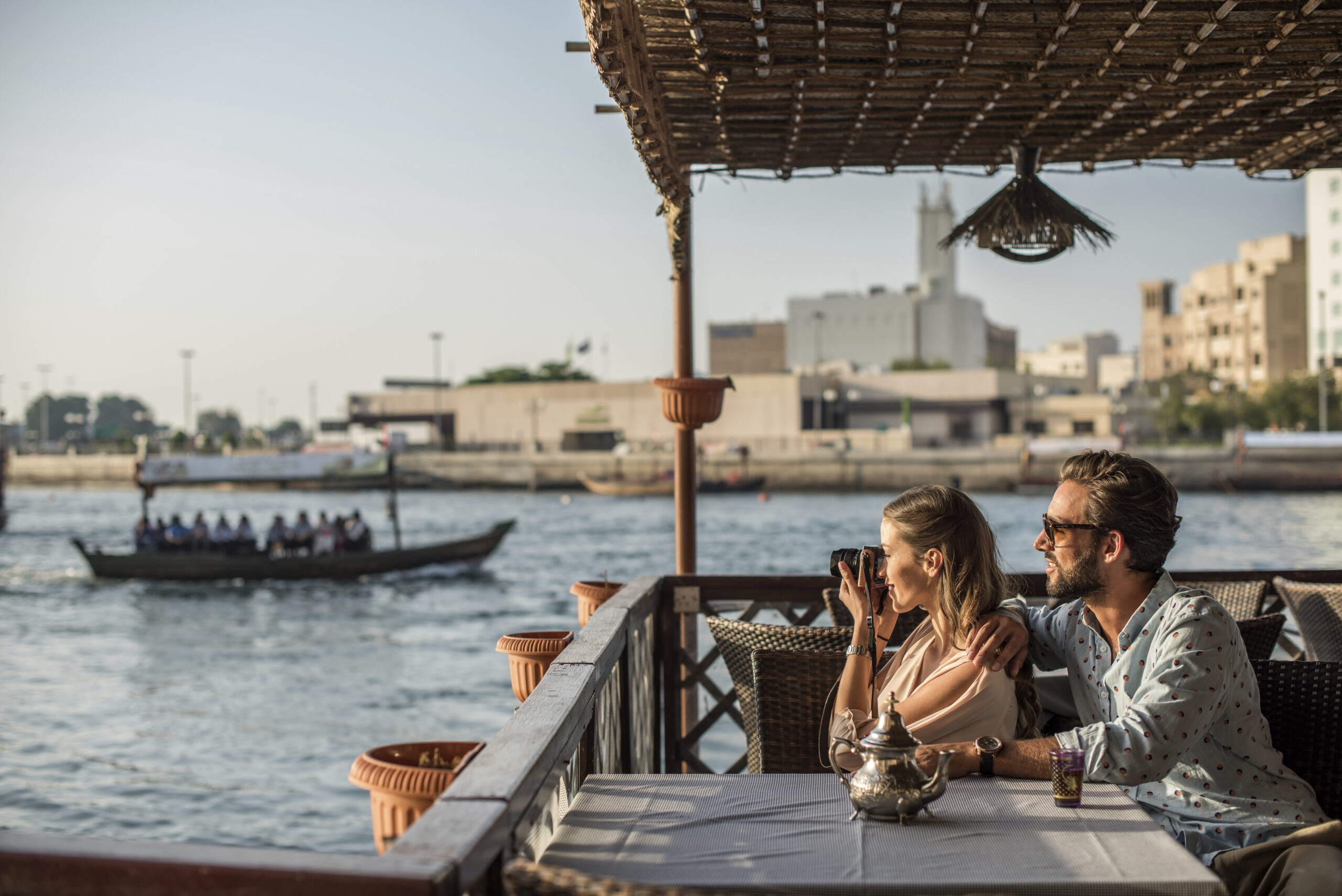 Romantic couple photographing from Dubai marina cafe, United Arab Emirates